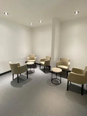 a waiting room with chairs and tables in a building at Super seven inn in Belgrade