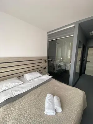 a bedroom with a large bed with two white pillows at Super seven inn in Belgrade