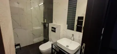 a white bathroom with a sink and a toilet at Super seven inn in Belgrade