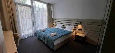a bedroom with a bed and a large window at Super seven inn in Belgrade