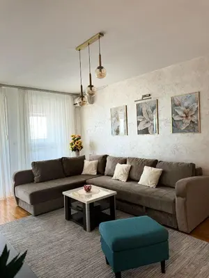 a living room with a couch and a table at MANHATTAN APARTMAN Belvil in Belgrade