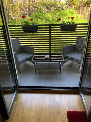 a patio with chairs and a table and a window at Porto23 in Belgrade