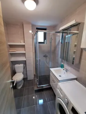 a bathroom with a shower and a toilet and a sink at Porto23 in Belgrade