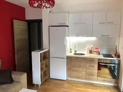 a kitchen with a white refrigerator in a room at Porto23 in Belgrade