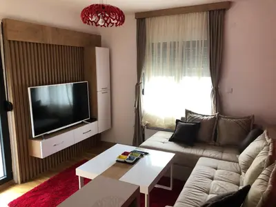 a living room with a couch and a flat screen tv at Porto23 in Belgrade