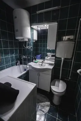 a bathroom with a sink and a toilet and a tub at Apartman ISKRA in Arandjelovac