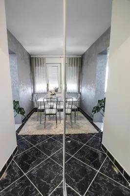 a dining room with a table and chairs at Apartman ISKRA in Arandjelovac