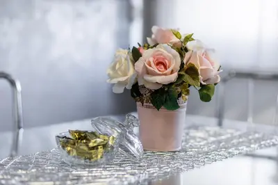 a vase with a bouquet of flowers on a table at Apartman ISKRA in Arandjelovac