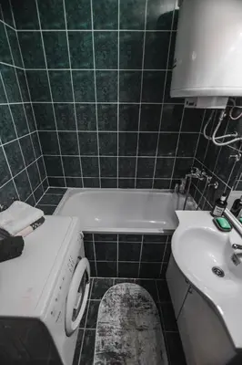 a bathroom with a sink and a washing machine at Apartman ISKRA in Arandjelovac