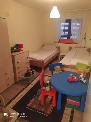 a small bedroom with two beds and a table at Dečiji vinogradi Belgrade, Sopot, Kosmaj in Sopot