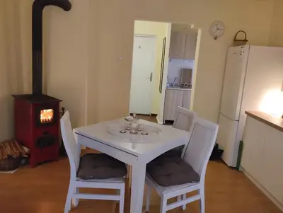 a white table and chairs in a kitchen with a stove at Dečiji vinogradi Belgrade, Sopot, Kosmaj in Sopot