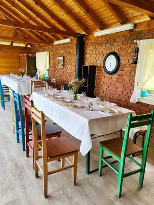 a long table with chairs and a clock in a room at Dečiji vinogradi Belgrade, Sopot, Kosmaj in Sopot