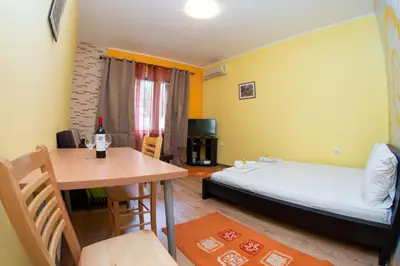 a small room with a bed and a table at Apartment Kalemegdan in Belgrade