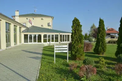 a large building with a sign in front of it at Hotel Dragović Smederevo in Smederevo