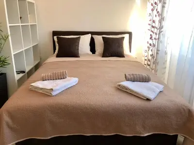 a bedroom with a large bed with two towels on it at Modern Studio (Institut Majka i Dete) in Belgrade