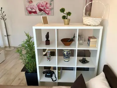 a white book shelf in a living room at Modern Studio (Institut Majka i Dete) in Belgrade