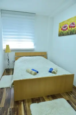 a bedroom with a bed with two pillows on it at Apartman Bazar in Smederevo