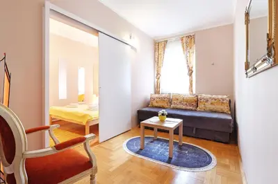 a living room with a couch and a table at Sava SQUARE Apartment in Belgrade