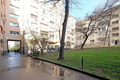 a wet street in front of a building at Sava SQUARE Apartment in Belgrade