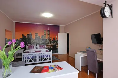 a room with a bedroom with a bed and a desk at Sava SQUARE Apartment in Belgrade