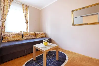 a living room with a couch and a table at Sava SQUARE Apartment in Belgrade