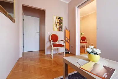 a living room with a table and two chairs at Sava SQUARE Apartment in Belgrade