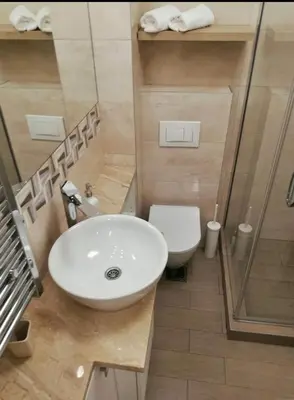 a bathroom with a sink and a shower and a toilet at Marco’s home in Vračar (historical)
