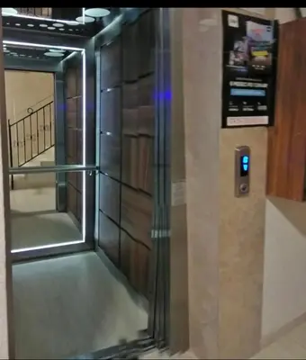 an elevator with a glass door in a building at Marco’s home in Vračar (historical)