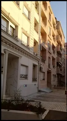 a large apartment building with a garage in front of it at Marco’s home in Vračar (historical)