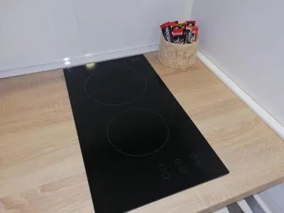 a black mat sitting on the floor next to a wall at FIT apartman in Belgrade