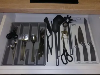 a group of utensils are arranged in a drawer at FIT apartman in Belgrade