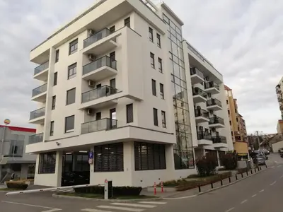 a white apartment building on a city street at FIT apartman in Belgrade