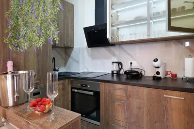 a kitchen with a bowl of fruit on a counter at Central SPA Galaxy Apartment in Belgrade