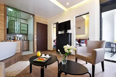 a living room with a bath tub and a table at Central SPA Galaxy Apartment in Belgrade