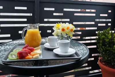 a tray of fruit and juice on a table at Central SPA Galaxy Apartment in Belgrade