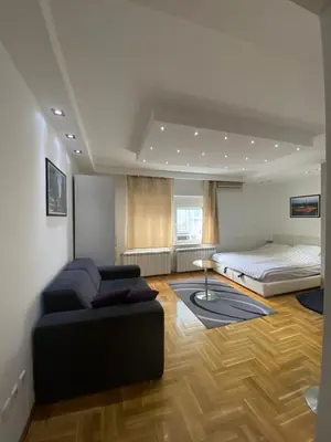 a living room with a couch and a bed at Cika Ljuba in Belgrade