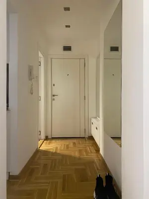 a hallway with a door and some shoes on the floor at Cika Ljuba in Belgrade