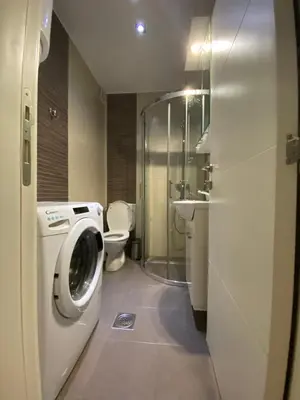 a bathroom with a washing machine and a toilet at Cika Ljuba in Belgrade