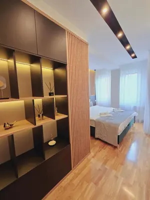 a bedroom with a bed and a desk and a bed sidx sidx sidx at Harmony Apartmani Arandjelovac in Arandjelovac