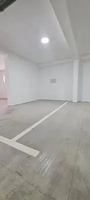 an empty parking garage with a large white room at Harmony Apartmani Arandjelovac in Arandjelovac