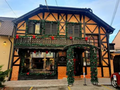 a building with a balcony and christmas decorations on it at Vila Geppetto in Belgrade