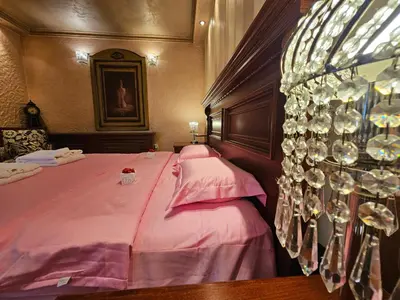 a room with a bed with wine glasses on the wall at Vila Geppetto in Belgrade