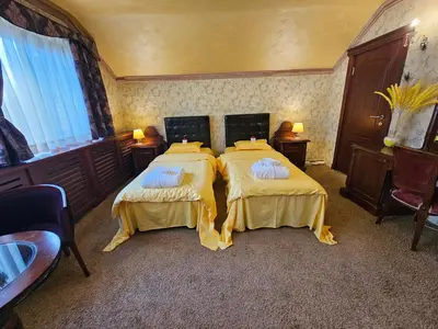 a bedroom with two beds with towels on them at Vila Geppetto in Belgrade