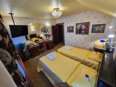 a room with two beds and a desk with a computer at Vila Geppetto in Belgrade