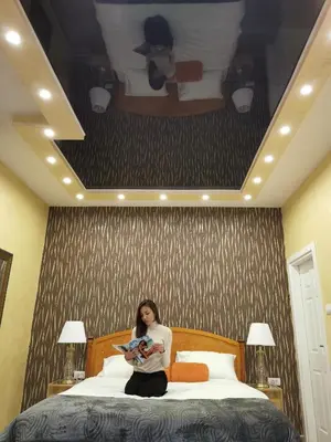 a woman sitting on a bed holding a baby at Contigo Apartments in Belgrade