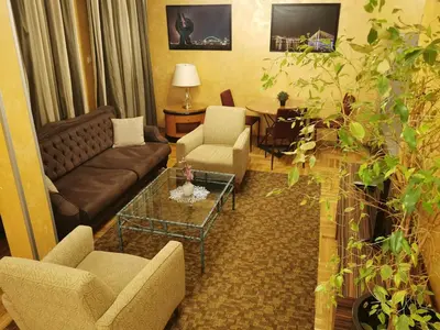 a living room with a couch and chairs and a table at Contigo Apartments in Belgrade
