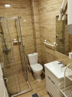 a bathroom with a shower and a toilet and a sink at Contigo Apartments in Belgrade