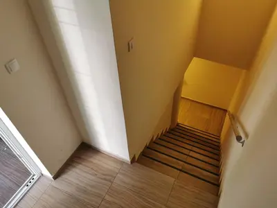 an empty room with a staircase with yellow walls at Contigo Apartments in Belgrade