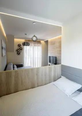 a bedroom with a bed and a living room at Belly3 in Belgrade