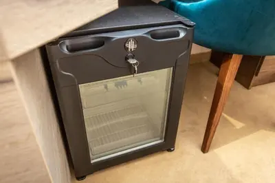 a stove sitting under a table next to a chair at HARIZMA 013 in Kovin
